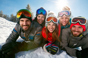 Wall Mural - friends having fun on ski holiday in mountains