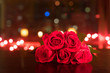 © kieferpix - Red roses on table against city lights. Love and romance concept.