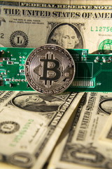 Wall Mural - silver bitcoin coin with dollars and computer motherboard, cryptocurrency mining concept