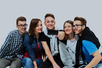 Sticker - Group of happy young teenager students taking selfie photo isolated on white background.