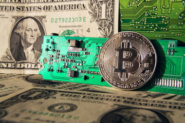 Wall Mural - silver bitcoin coin with dollars and computer motherboard, cryptocurrency mining concept