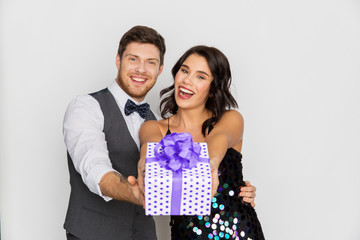 happy couple with gift box at birthday party