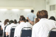 © Chinnapong - Blur school background university students writing answer doing exam in classroom ..