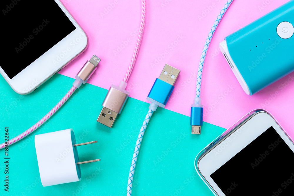 USB charging cables for smartphone and tablet in top view - obrazy, fototapety, plakaty 