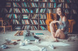 Young woman writer in library at home creative occupation laughing