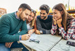 © Mediteraneo - Group of four friends having fun a coffee together. Two women and two men at cafe talking laughing and enjoying their time