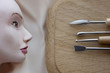 A handmade doll, a mannequin, plinth, tools for making dolls