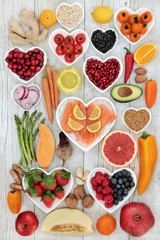 Wall Mural - Health food for a healthy heart with vegetables, fruit, fish, nuts, seeds, supplement powders, pulses, cereals, spices and herbs used in herbal medicine. High in omega 3, anthocyanins  & antioxidants 