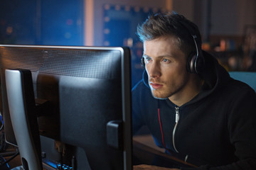 Portrait of serene software specialist hearing songs while working with digital device at desk. Appliance and profession concept