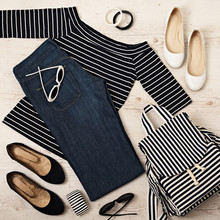 Female Summer Outfit - Navy Jeans, Striped Top, Sunglasses, Backpack.