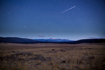 shooting star over the moreno valley in new mexico under moon light