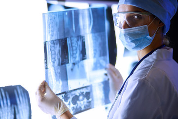 Two female women medical doctors looking at x-rays in a hospital.