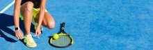 Tennis Athlete Player On Getting Ready Tying Running Shoe Laces During Game On Outdoor Blue Hard Court. Banner Panorama.