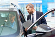© Seventyfour - Portrait of handsome young man taking luxury car for test drive, sitting inside with  sales manager in showroom