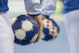 Handball players holding balls for handball