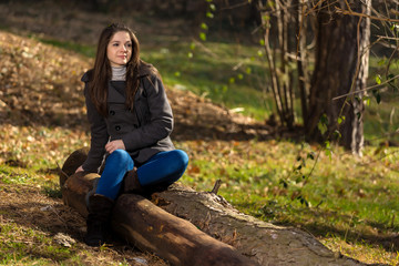 young woman in the forest posing