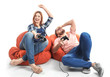 © Africa Studio - Emotional couple playing video game on white background