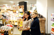 © lado2016 - Two women choosing a dairy products at supermarket