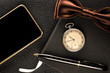 Men's accessories are watch, pen, phone and bow-tie