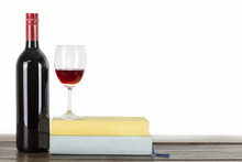 Wine Bottle And Wine Glass On Old Empty Book Cover On Wooden Table Isolated White Background Copyspace.