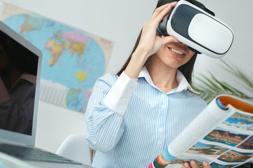 Young female travel agent consultant in tour agency virtual reality headset