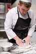 © Photodrive - Chef preparing traditional italian pizza dough, his hands and apron covered in flour. Cooking can be messy