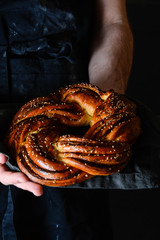 Wall Mural - Baker's hands with a bread. food cooking, baking and people concept