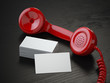 Mockup of  blank business cards and  red retro phone receiver  on  the black wooden desk background.