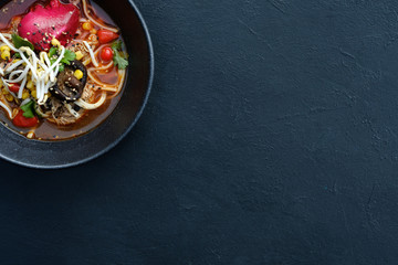 Wall Mural - Ramen dish on dark background. Traditional Asian fast food meal. Delicious noodle soup