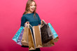portrait of beautiful cute happy sweet surprised blonde woman girl looking in big shopping bag