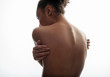 © Yakobchuk Olena - Close up of female nude back in good shape with smooth healthy skin embracing herself. Isolated on background. Loneliness concept