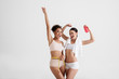© Yakobchuk Olena - Portrait of positive women making achievement in losing weight. They are demonstrating beautiful forms of their figures. Copy space in left side. Isolated on background
