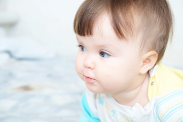 cute baby poatrait close up, caucasian blue eyes cheerful infant playing