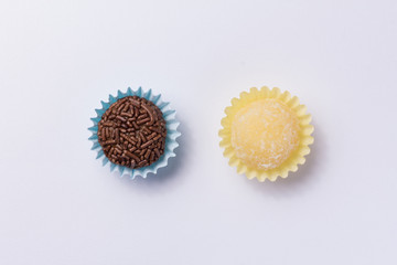 Brazilian sweets: Beijinho and Brigadeiro. Children birthday parties. Flat lay design of candy ball. Macro, close up.