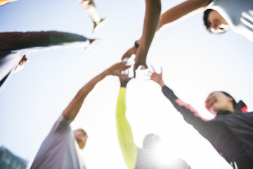 Diverse people joined hands together