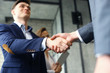 © ty - Business people shaking hands, finishing up a meeting.