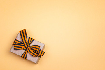 Wall Mural - Gift box with st george ribbons on the yellow background. Space for text.