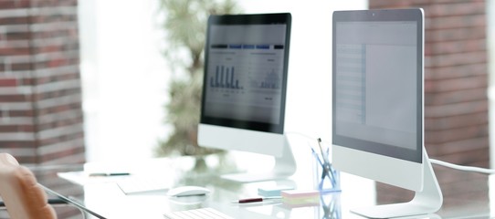 close-up of the screens of personal computers on a modern workplace in the office.
