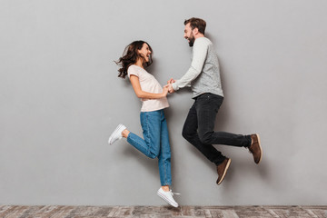 Canvas Print - Full length portrait of a cheery young couple