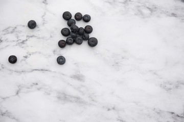 Small pile of blueberries on a marble background, with copy space 