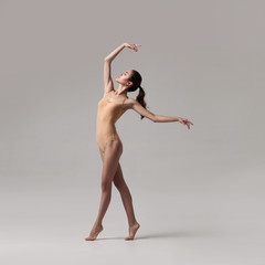 young beautiful dancer in beige swimsuit