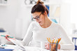© Kalim - Woman working in her home office