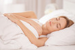 © Africa Studio - Young woman sleeping on white pillow in bed