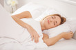 © Africa Studio - Young woman sleeping on white pillow in bed