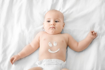 cute baby with body cream on tummy
