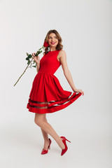 Poster - Portrait of a happy young woman dressed in red dress