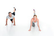 © LIGHTFIELD STUDIOS - smiling sportive couple exercising together isolated on white