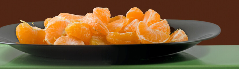 Wall Mural - image of a tangerine on a plate close up