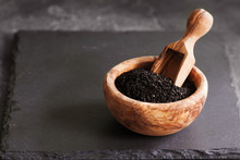 Black Cumin Or Nigella Sativa Or Kalonji Seeds In Bowl With Spoon On Black Slate Background, Selective Focus