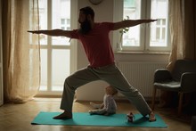 Man Performing Yoga On Exercise Mat